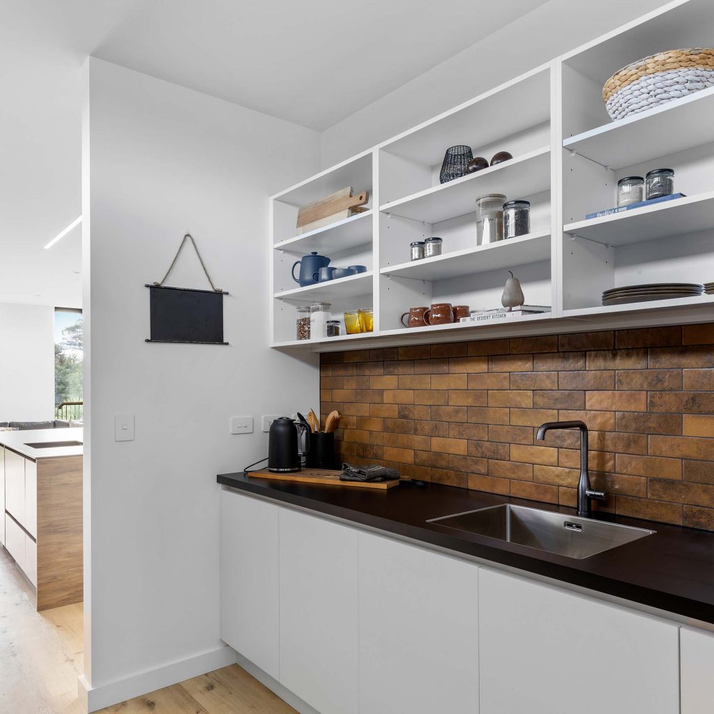 Kitchens-By-John-Prosser-Riverhead-Showroom-Dark-Wood-Kitchen=Pantry-Brick